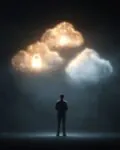 Mann stehend mit leuchtenden holografischen Wolken- mit Schloss-Symbolen – Symbol für Cloud-Sicherheit und Datenschutz.