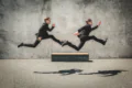 twins in black suits jumping